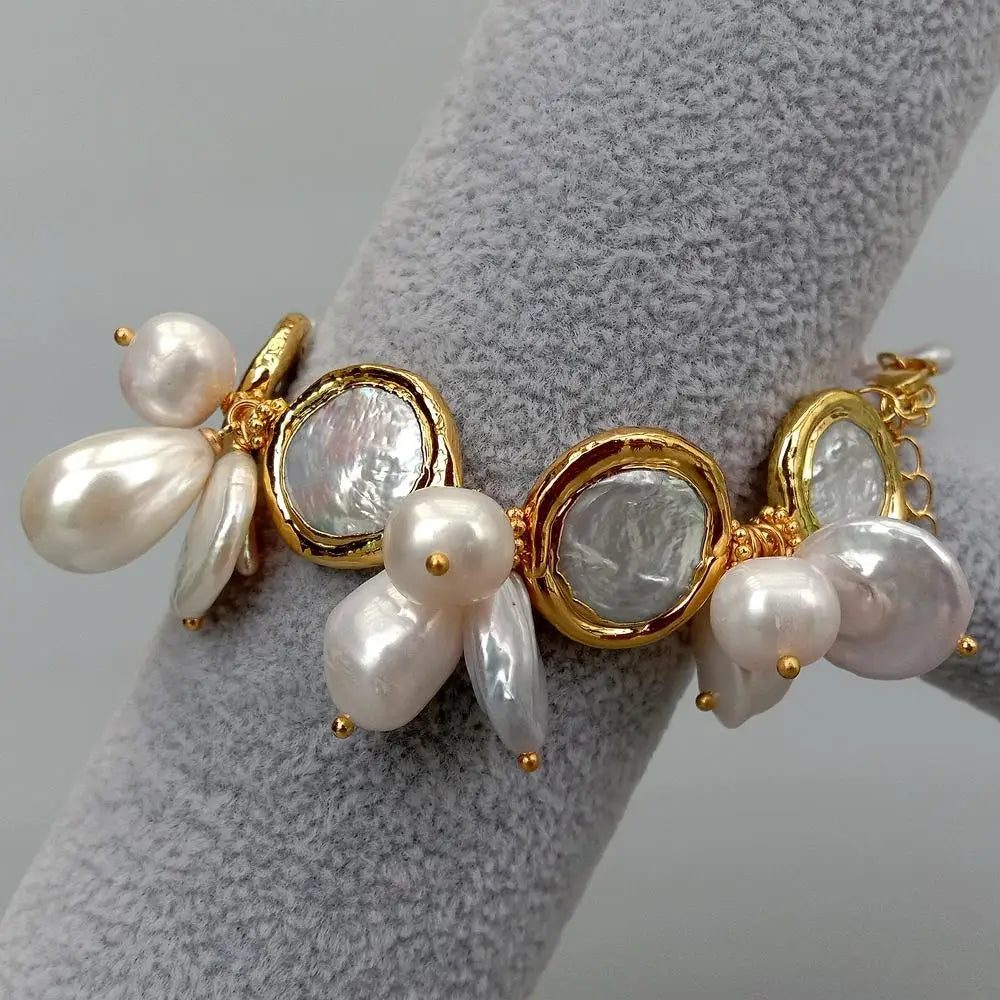 Bracelet with pearls and gold accents on a gray stand
