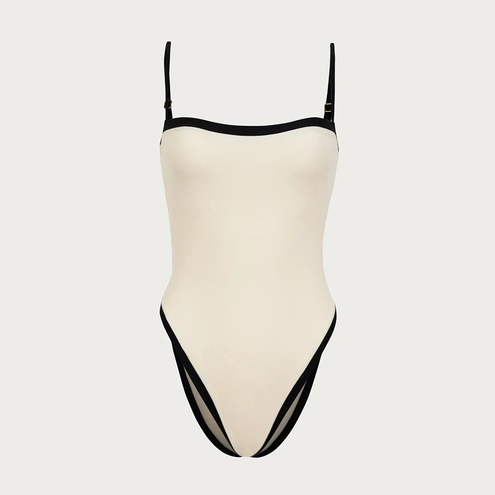 Beige swimsuit with black trim on a light gray background