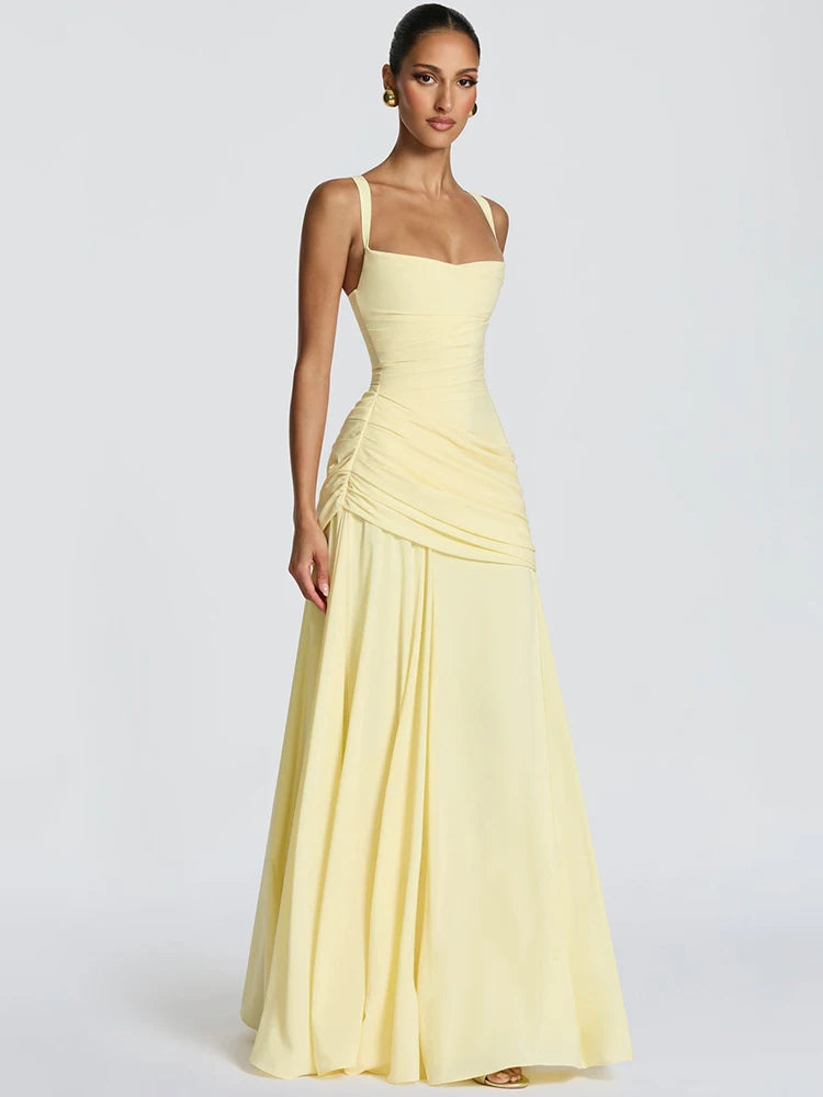 Woman wearing a light yellow evening gown on a white background