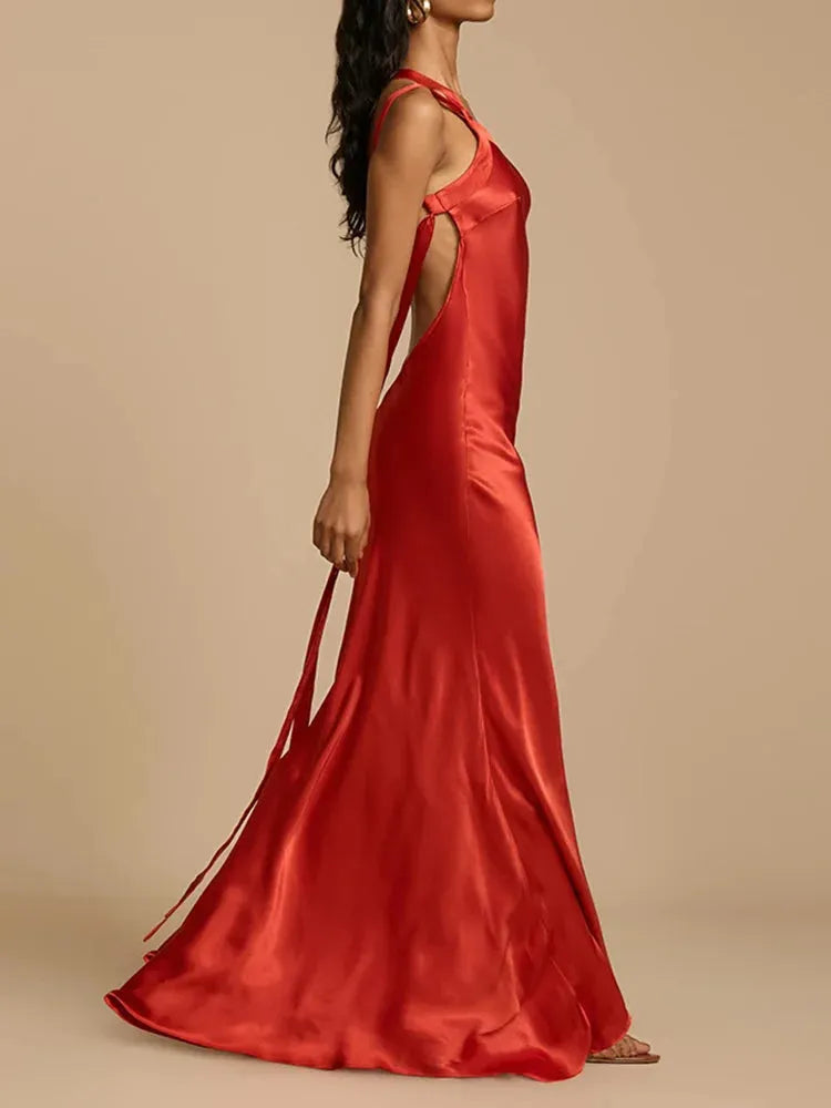 Satin red evening gown on a neutral background