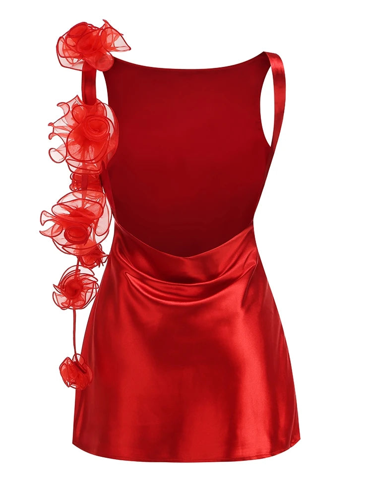 Red satin dress with floral embellishments on a white background