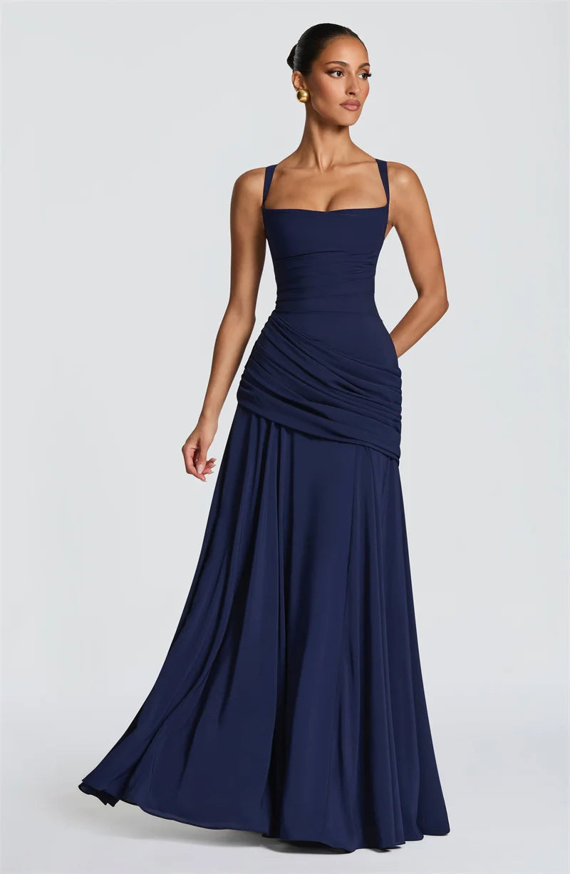 Woman wearing a navy blue evening gown on a white background