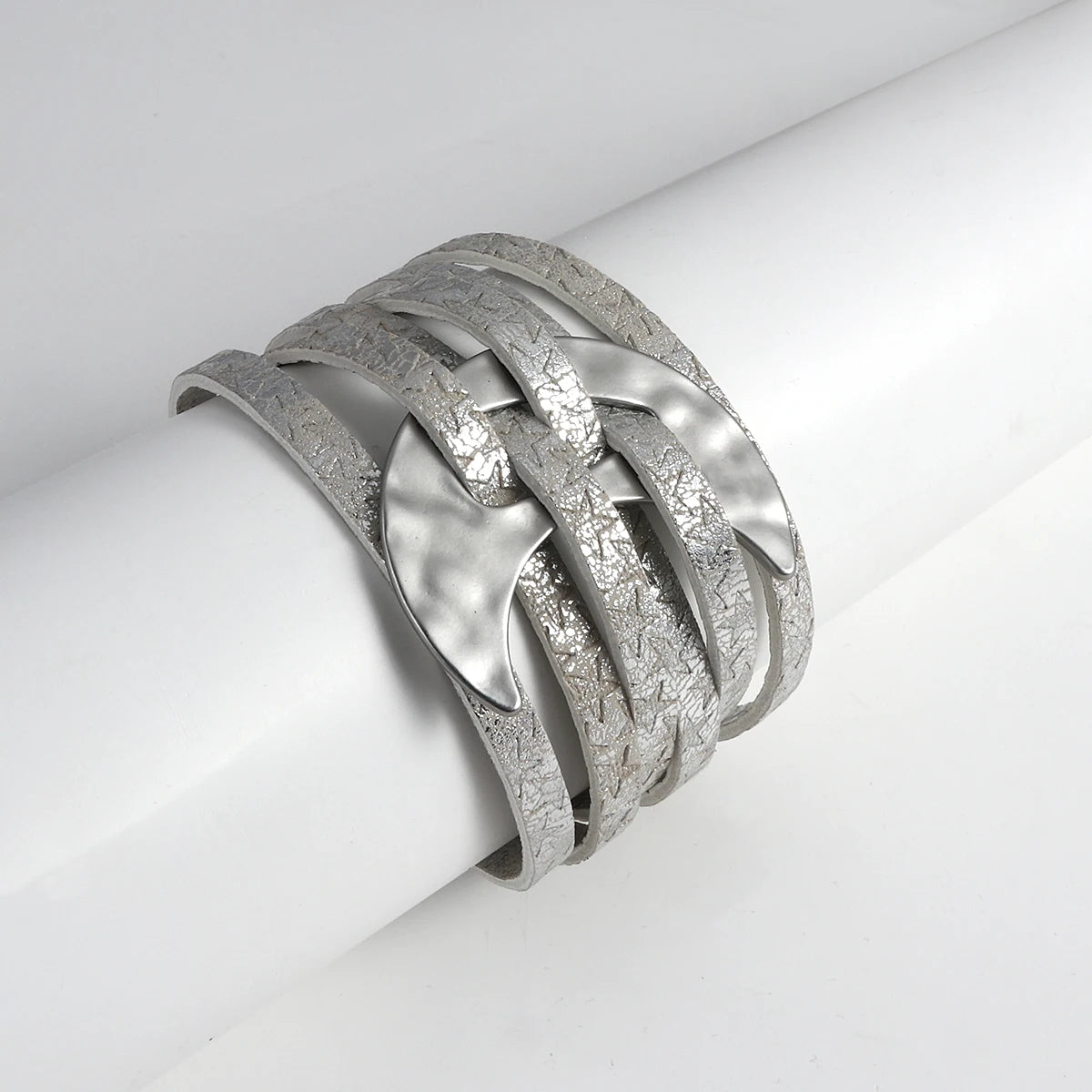 Silver bracelet with braided design on a white surface