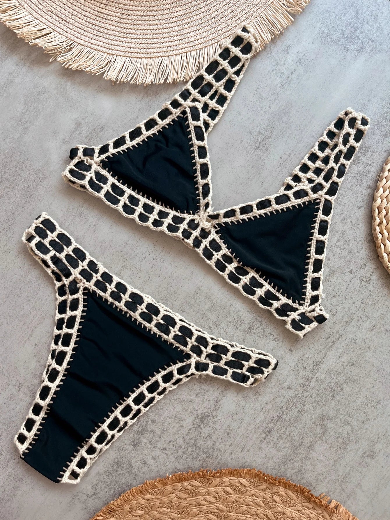 Black bikini with white patterns on a gray surface