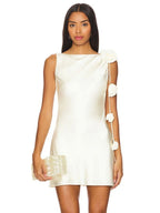 Woman wearing a white dress with floral arm sleeves on a white background