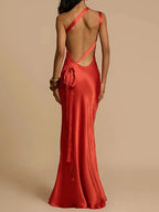 Red evening gown with open back on a plain background