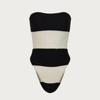 Black and beige strapless swimsuit on a light gray background