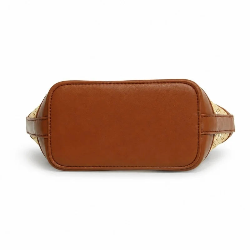 A brown leather belt bag shown from the back, featuring a smooth tan leather back panel and woven beige and brown patterned side straps, photographed on a solid white background.
