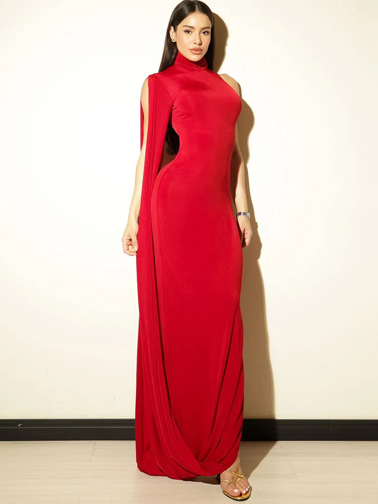 Woman wearing a red evening gown against a plain background