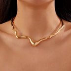 Gold necklace on a person's neck with a close-up view
