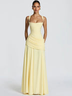 Woman wearing a yellow strapless gown on a white background