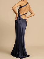 Navy blue evening gown with open back on beige background