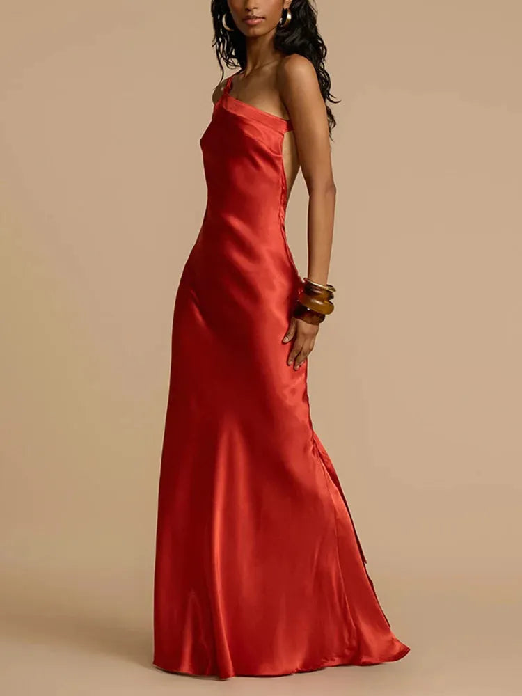 Model wearing a red evening gown against a plain background.