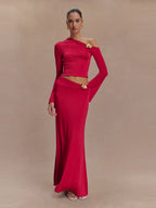 Woman wearing a red one-shoulder dress with gold accents on a beige background