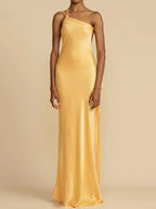 Yellow satin evening gown on a neutral background