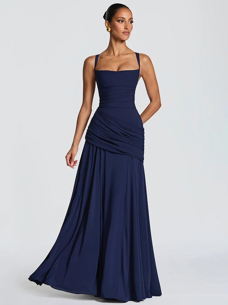 Woman wearing a navy blue gown against a light gray background