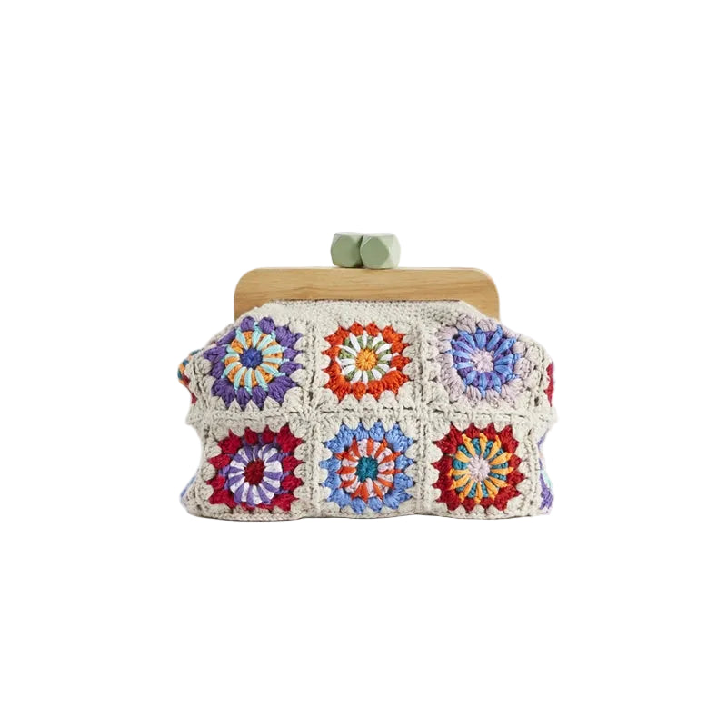 Colorful crochet clutch bag with wooden frame on a white background