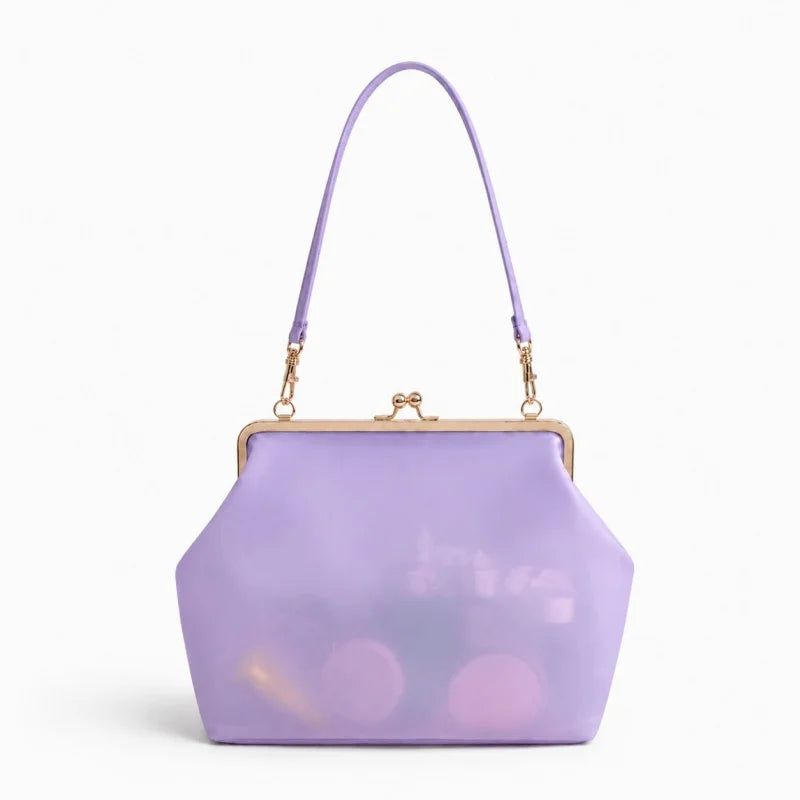 A lavender translucent clutch handbag with a gold-tone kiss-lock frame and a matching lavender shoulder strap, shown on a clean white background.