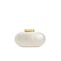 White oval container with gold lid on a white background