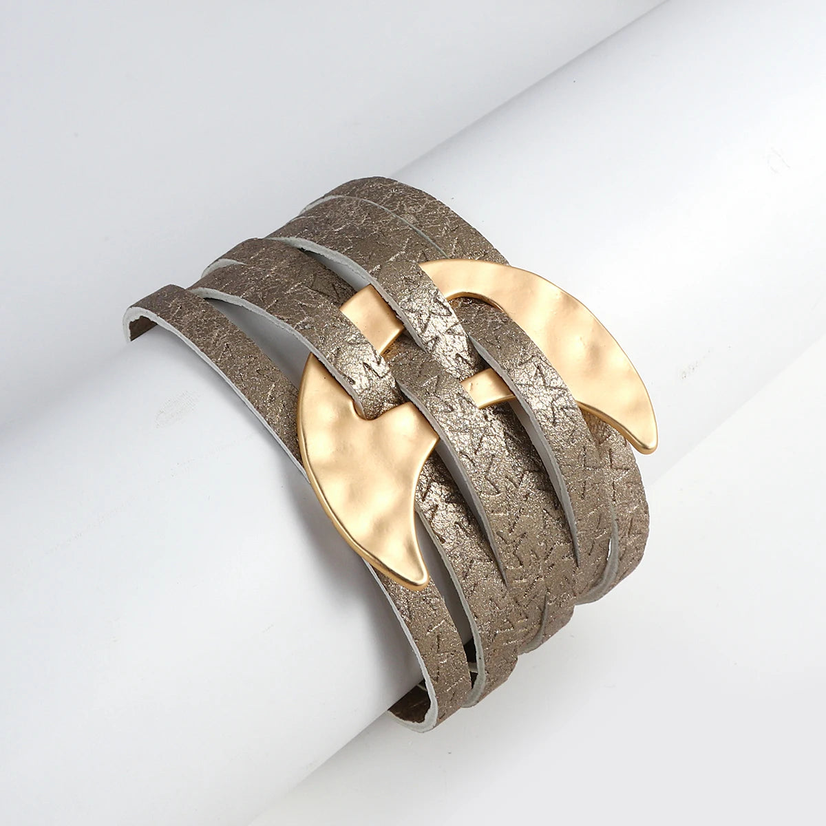Bracelet with gold and silver design on a white background
