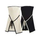 A white strapless mini dress with a solid backless design above knee, featuring a black belt.