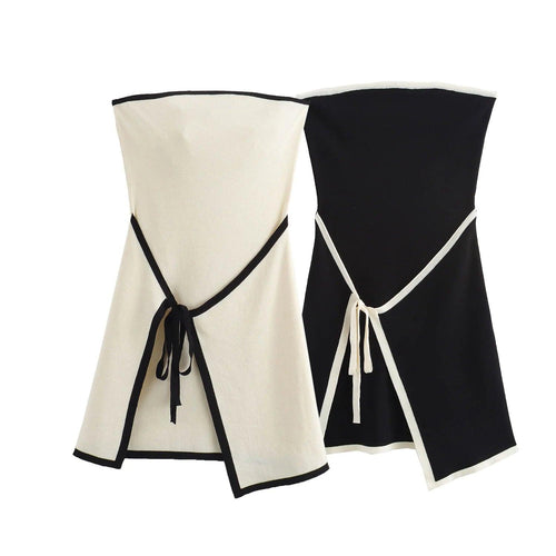 A white strapless mini dress with a solid backless design above knee, featuring a black belt.