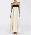 Two-tone dress with black top and white skirt worn by a model on a plain background.