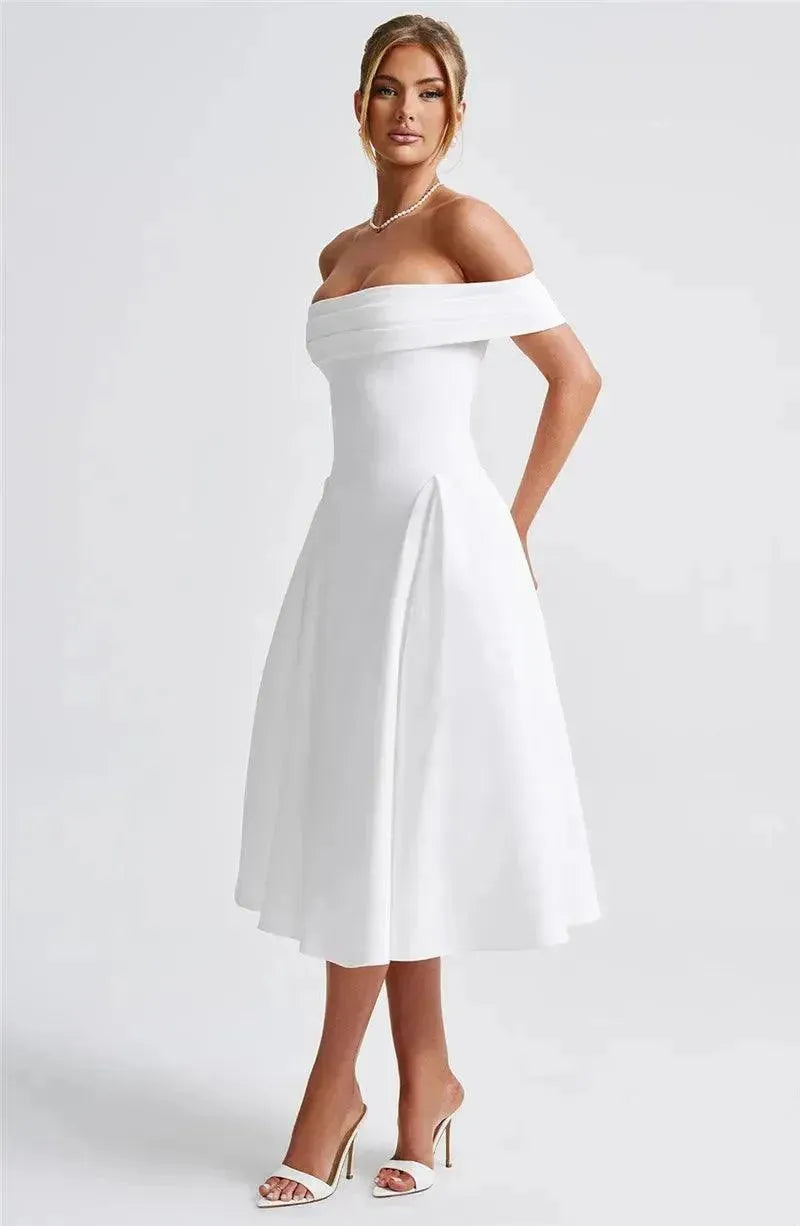 Woman wearing a white off-shoulder dress on a plain background