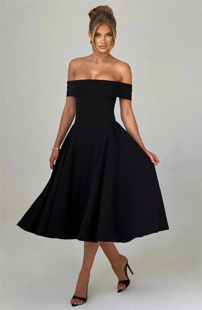 Woman wearing a black off-shoulder dress against a plain background