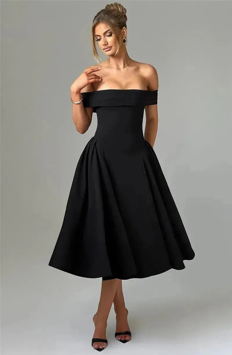Woman wearing a black off-shoulder dress on a plain background