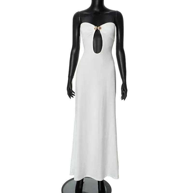 White evening gown on a mannequin against a plain background
