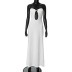 White evening gown on a mannequin against a plain background