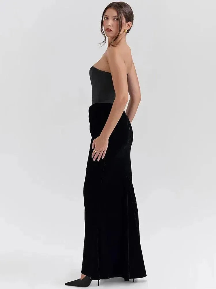 Model wearing a black strapless gown on a white background.